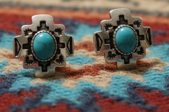 Small silver-tone western stud earrings with turquoise-style center stones and geometric engraved detail, approximately half an inch in size.