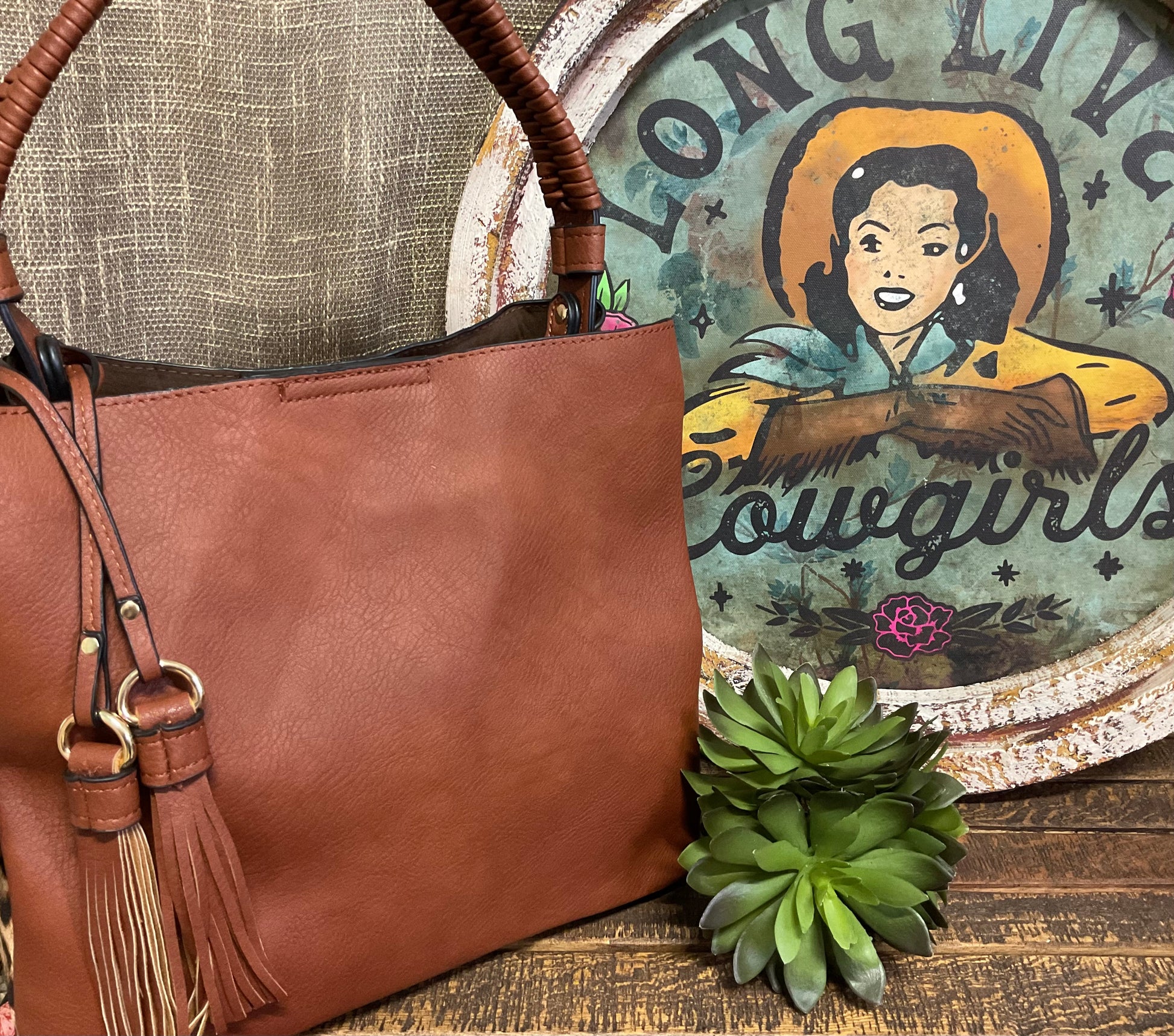 Tomball Leopard Contrast Bag in warm brown vegan leather with bold leopard-print sides, braided handle, and removable tassels – versatile, stylish handbag for day-to-night wear.