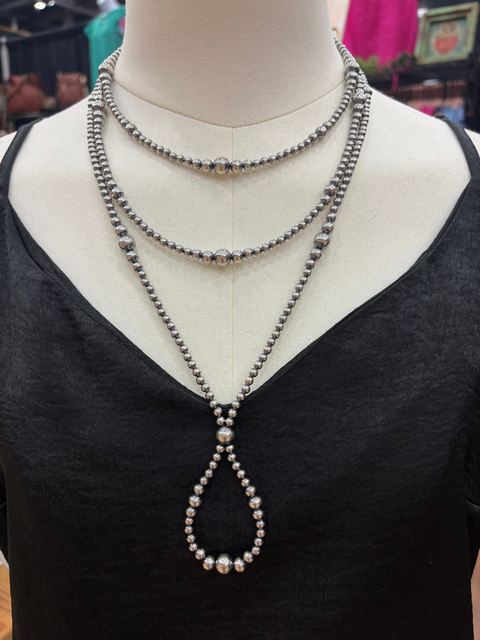 Sterling silver graduated pearl necklace with a hoop design styled at 23 inches in length. Pairs effortlessly with layered Western jewelry for a bold and classic statement.