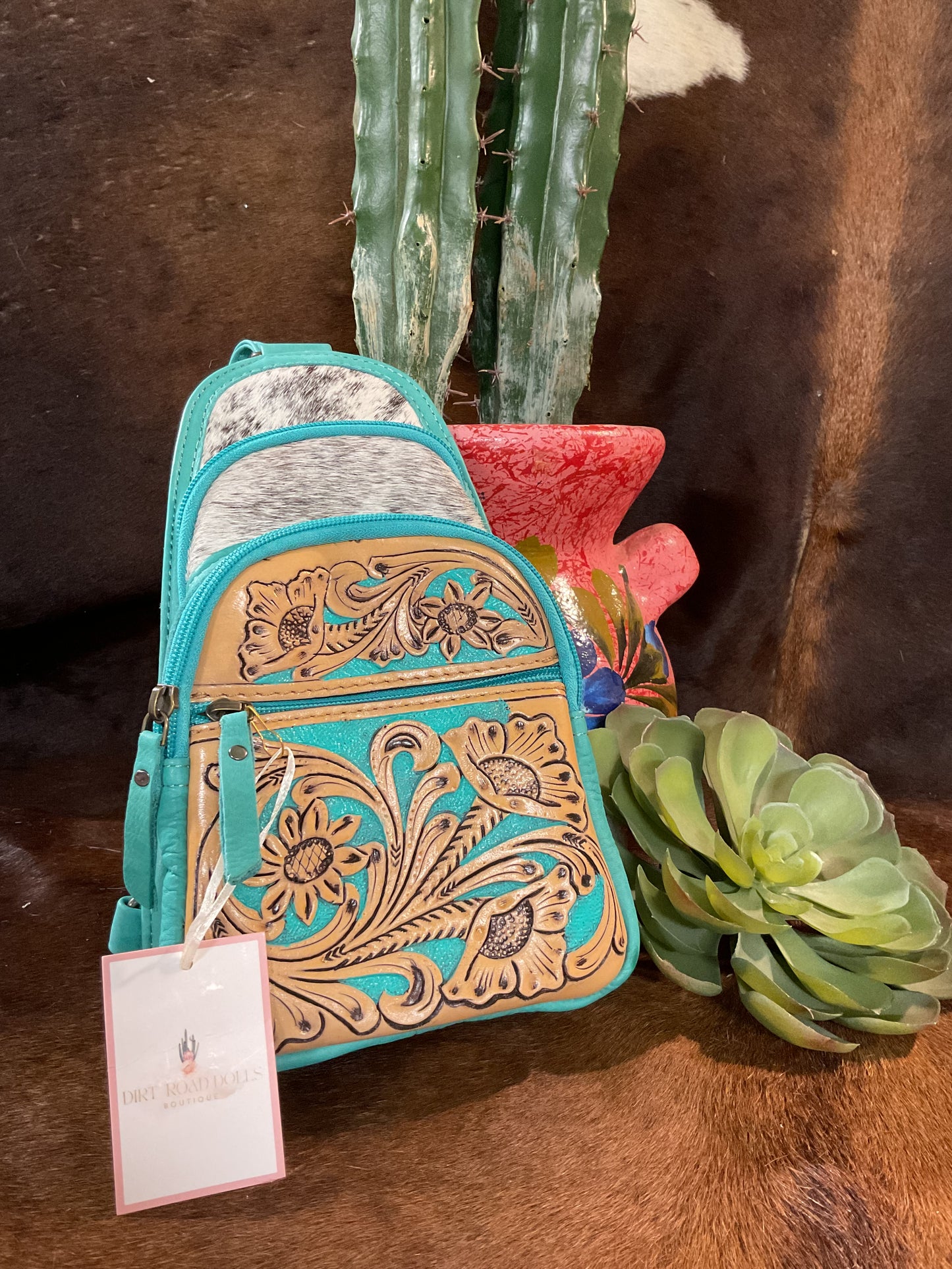 Plano Bum Bag in turquoise, featuring a blend of tooled leather and hair-on hide for a stylish, western-inspired look.