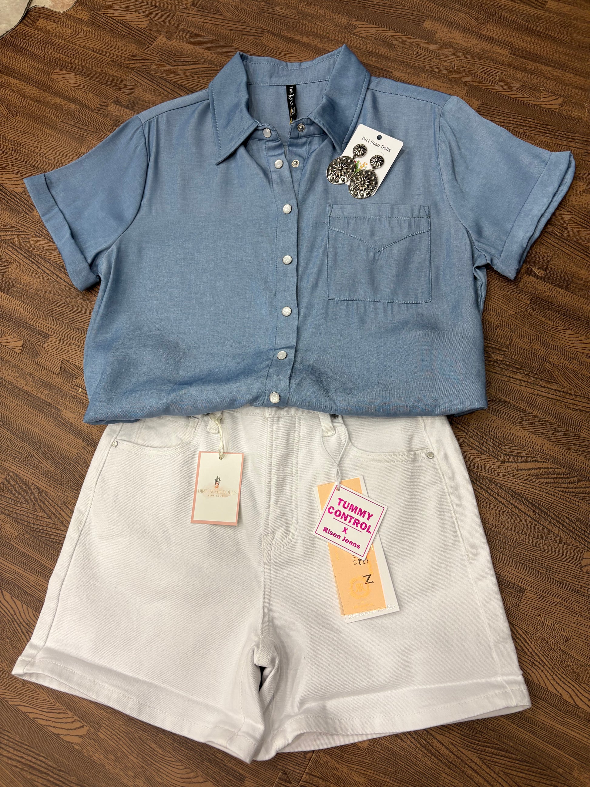 Pecos Pearl Snap Top in soft tencel-cotton blend with classic pearl snaps – short sleeve western shirt for women, true to size fit.  Shown as flat lay with white denim shorts and silver earrings