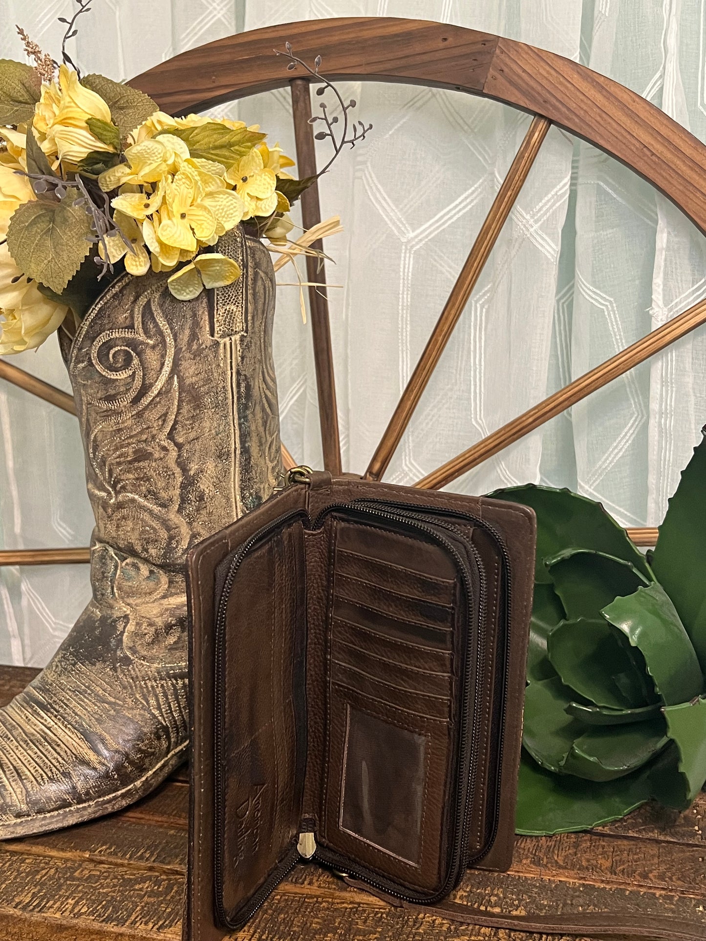 American Darling June Crossbody in hand-tooled leather, available in a classic design or tooled cactus design with green and pink accents, shown with adjustable crossbody and wristlet straps. Inside compartments offer excellent organization