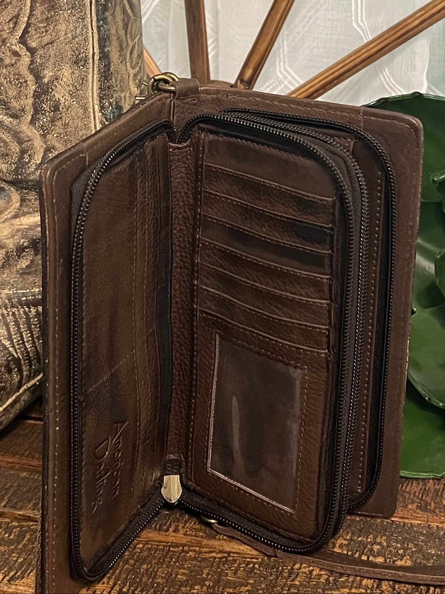 American Darling June Crossbody in hand-tooled leather, available in a classic design or tooled cactus design with green and pink accents, shown with adjustable crossbody and wristlet straps. Inside compartments offer excellent organization