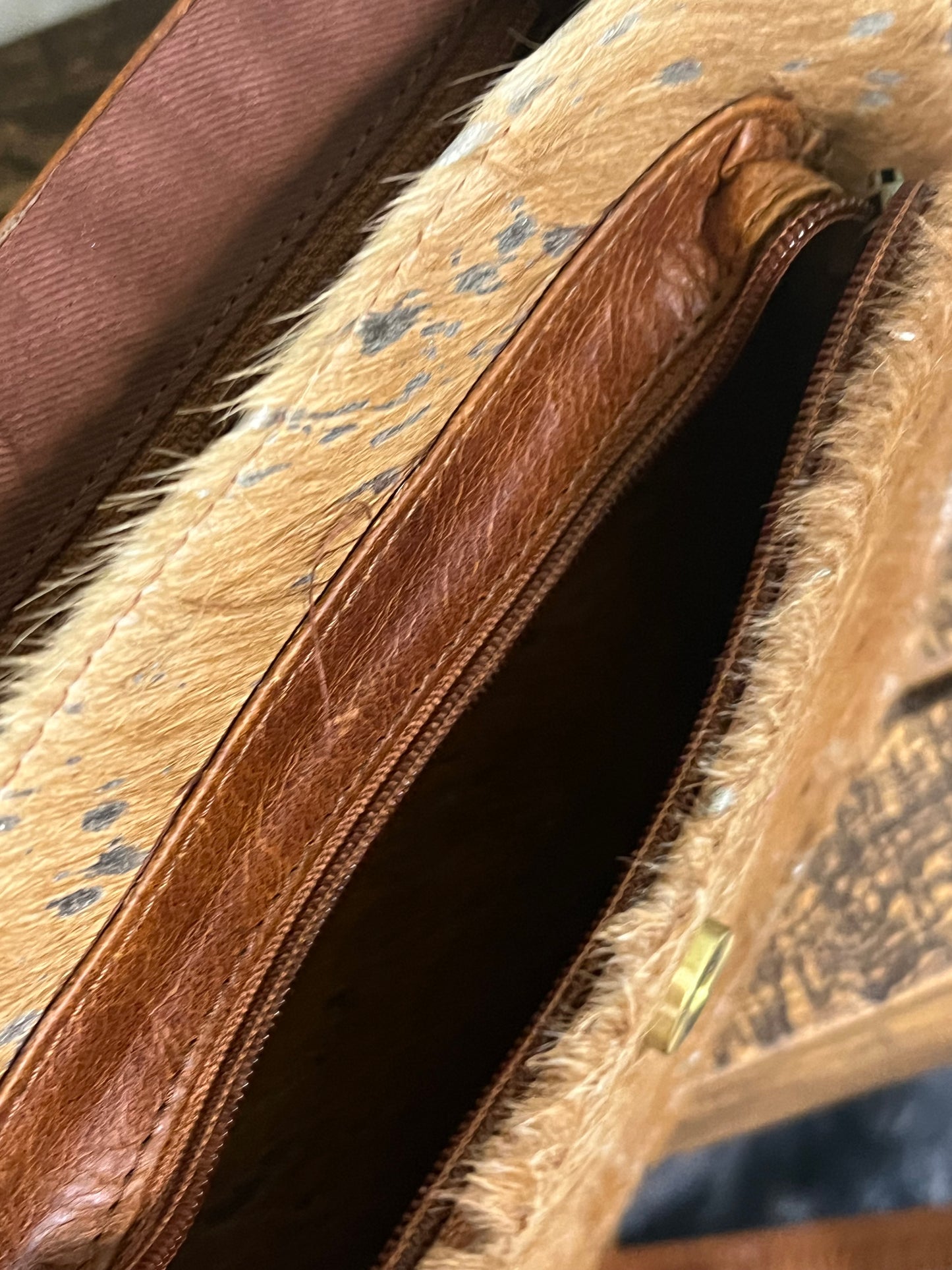 Falls City Bag by Crazy Heifers – handmade leather and cowhide bag with silver splatter design, adjustable strap, zippered front pocket, and magnetic snap closure.