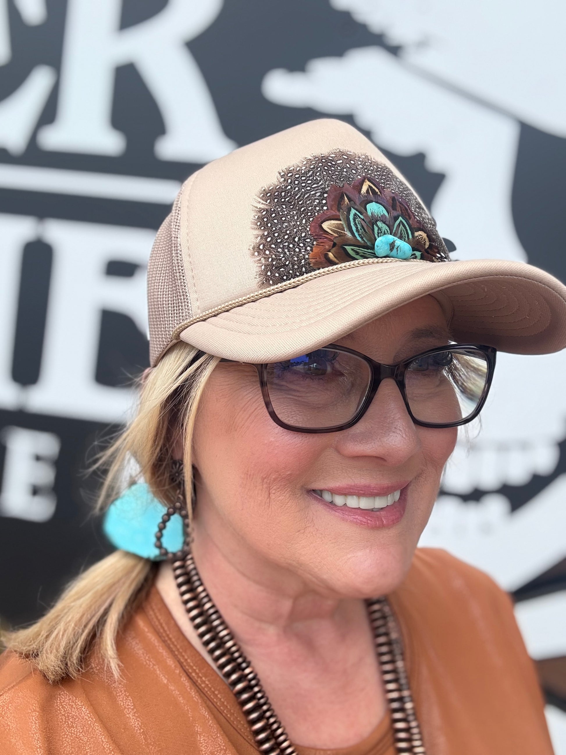 vintage-inspired trucker caps, each featuring feathered designs with a retro western vibe