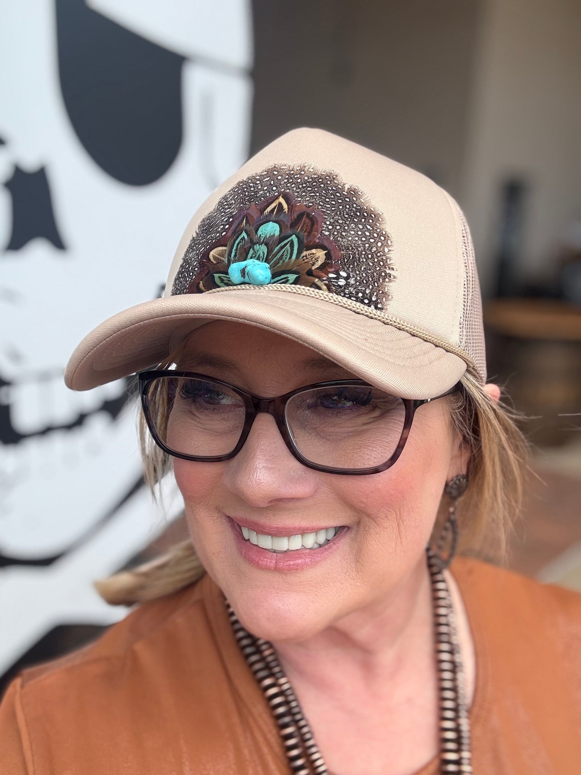 vintage-inspired trucker caps, each featuring feathered designs with a retro western vibe