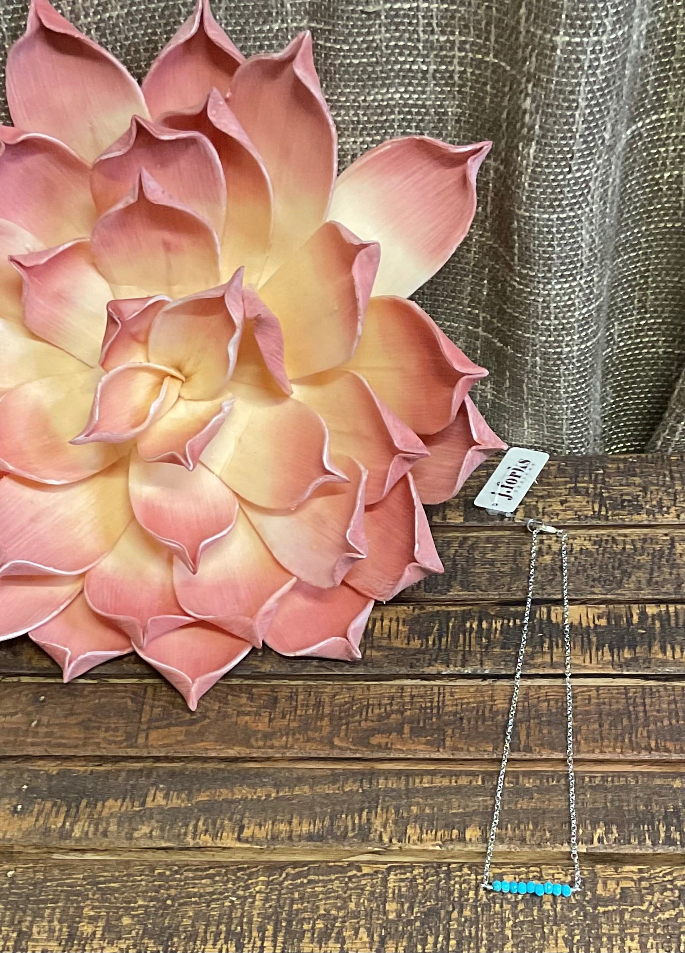 Close-up of the Parita Kingman Turquoise Necklace, a 16-inch silver chain featuring a faceted Kingman Turquoise center stone, displayed against a neutral backdrop with soft lighting.