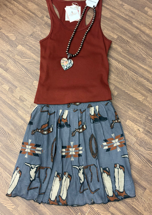 Grey flowy skort with built-in shorts featuring western-themed print of boots, spurs, ropes, and Aztec motifs