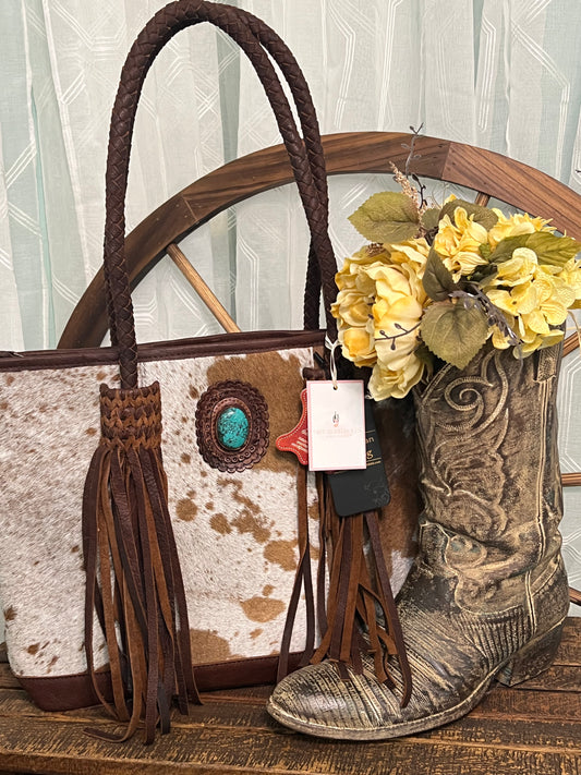 Round Rock Tote – full-grain leather tote with hair-on cowhide, leather fringe, and turquoise stone accent – luxury western-style statement bag.