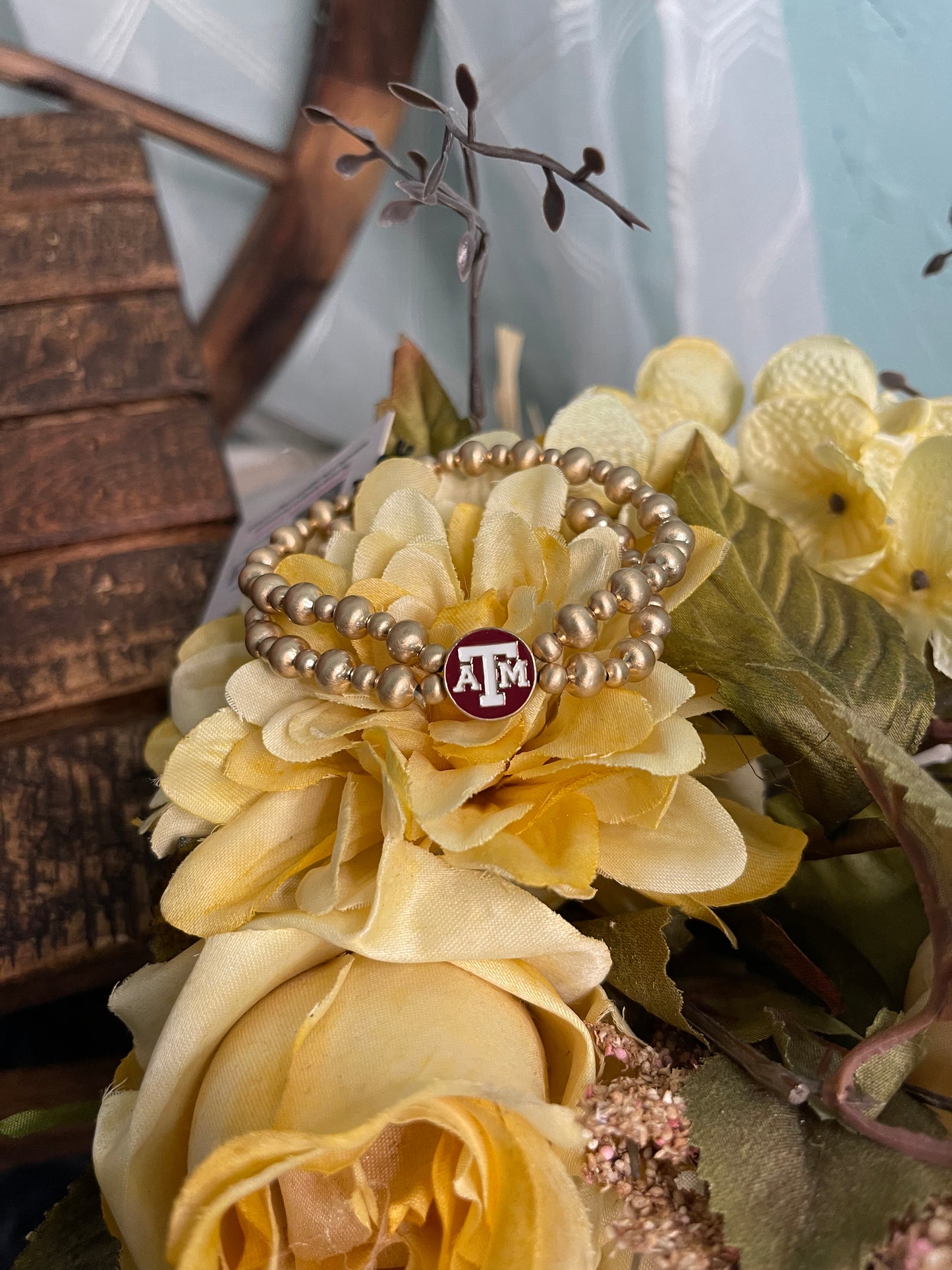 double strand gold plated beaded stretch bracelet with maroon and white Texas A&M University enamel logo