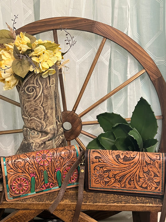 American Darling June Crossbody in hand-tooled leather, available in a classic design or tooled cactus design with green and pink accents, shown with adjustable crossbody and wristlet straps.