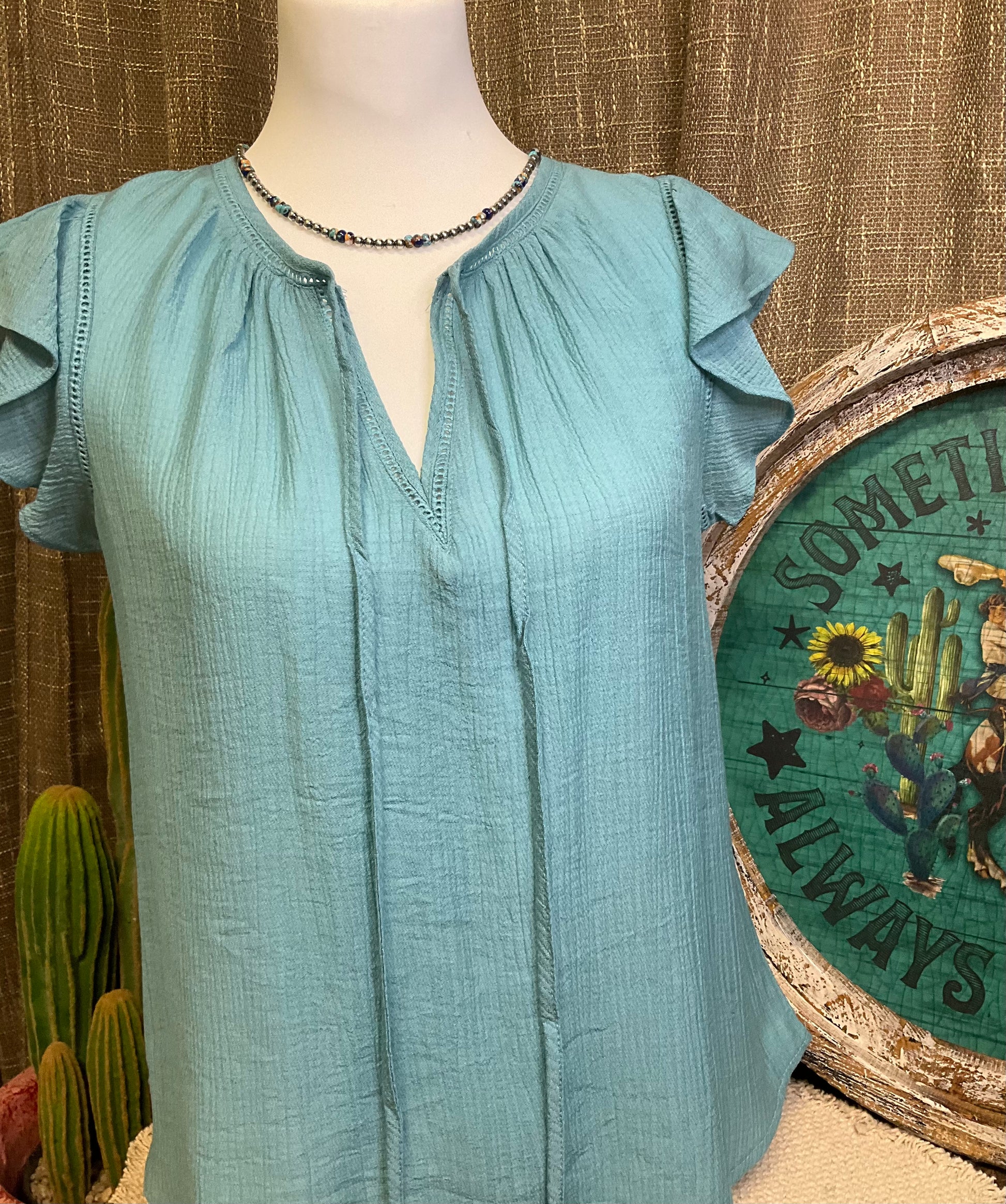 Leslie Ruffle Sleeve Top featuring feminine ruffle sleeves, offering a perfect blend of comfort and style.