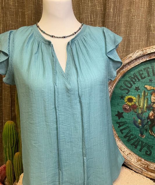 Leslie Ruffle Sleeve Top featuring feminine ruffle sleeves, offering a perfect blend of comfort and style.