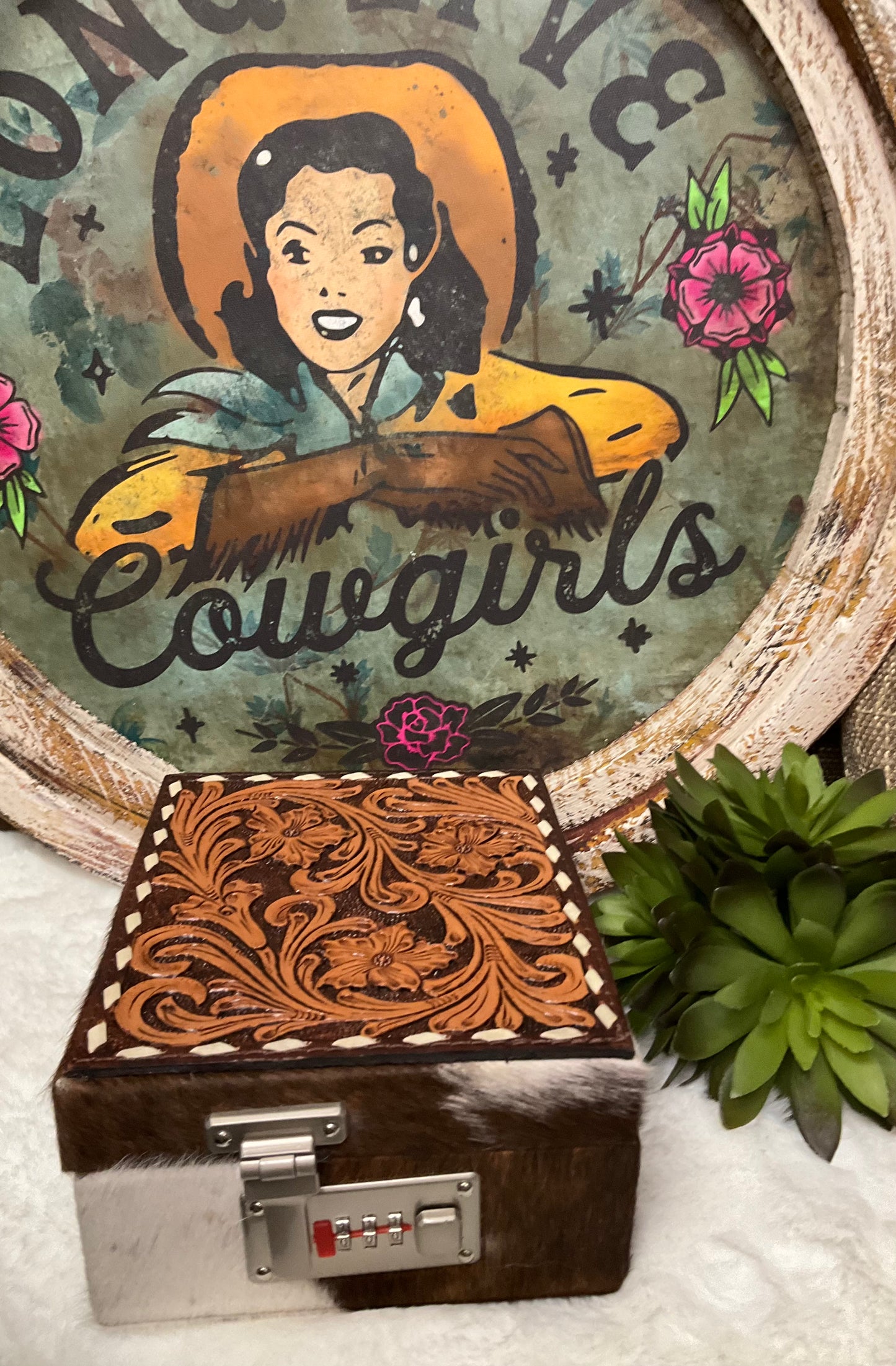 Hand-tooled leather and hair-on cowhide El Paso Jewelry Case by American Darling with 15 sections, snap closure straps, and a secure locking feature.