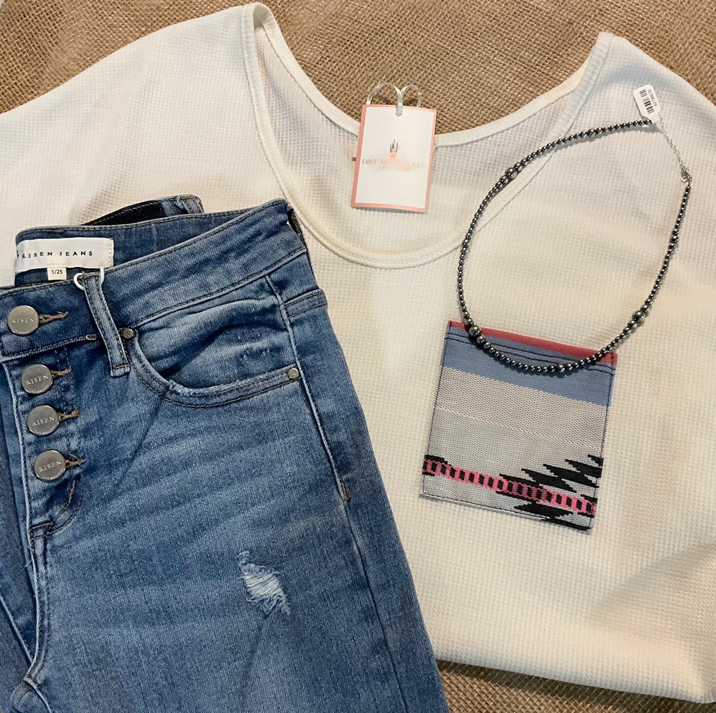 Sasha Top in a cozy waffle knit fabric with a short sleeve silhouette, scoop neckline, and rounded hem. Features an Aztec-inspired chest pocket for a pop of southwestern style. Available in ivory or heather grey.