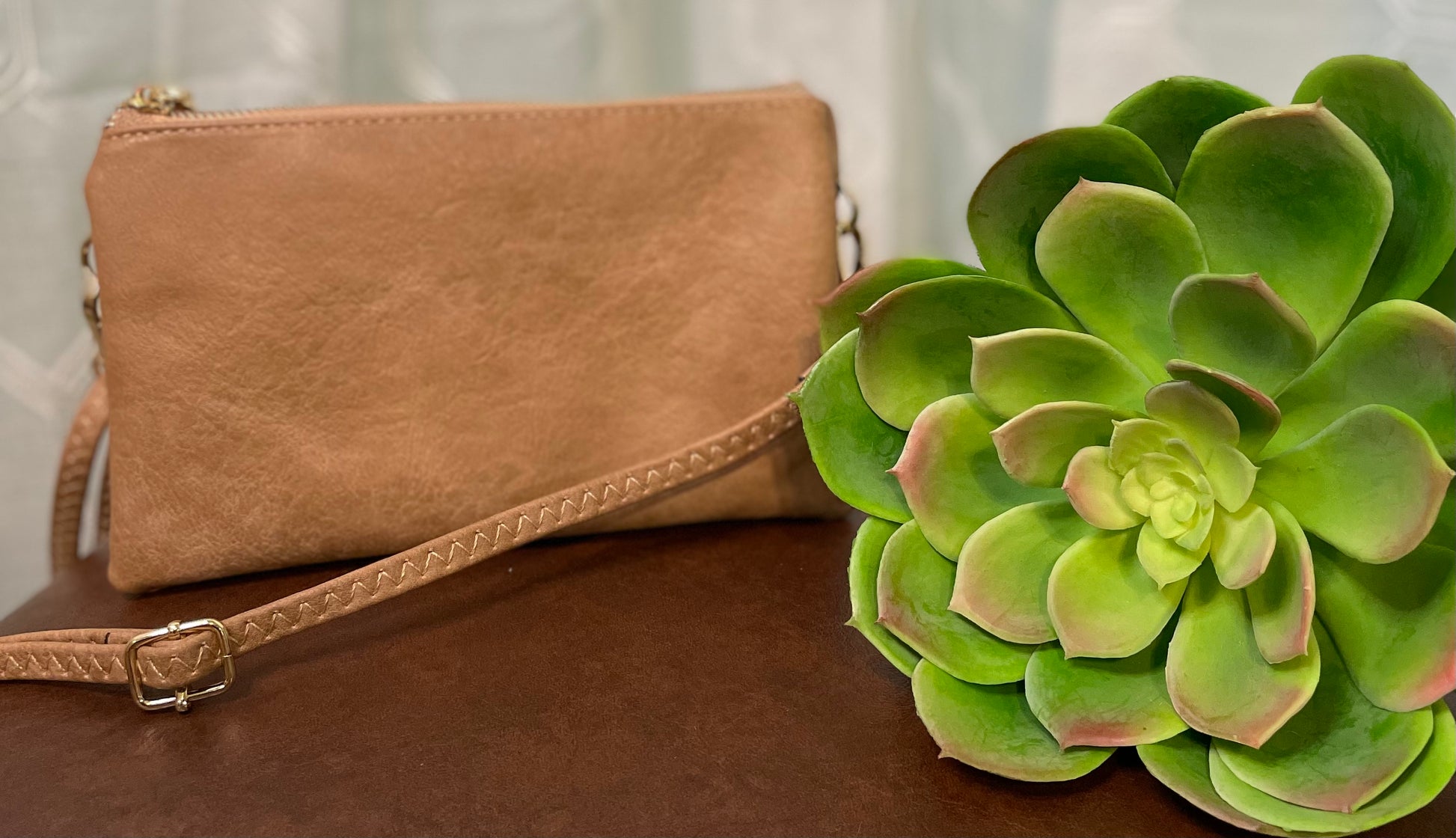 Poteet Crossbody bag with three compartments and built-in card holders, offering versatile crossbody and wristlet carrying options for stylish convenience.