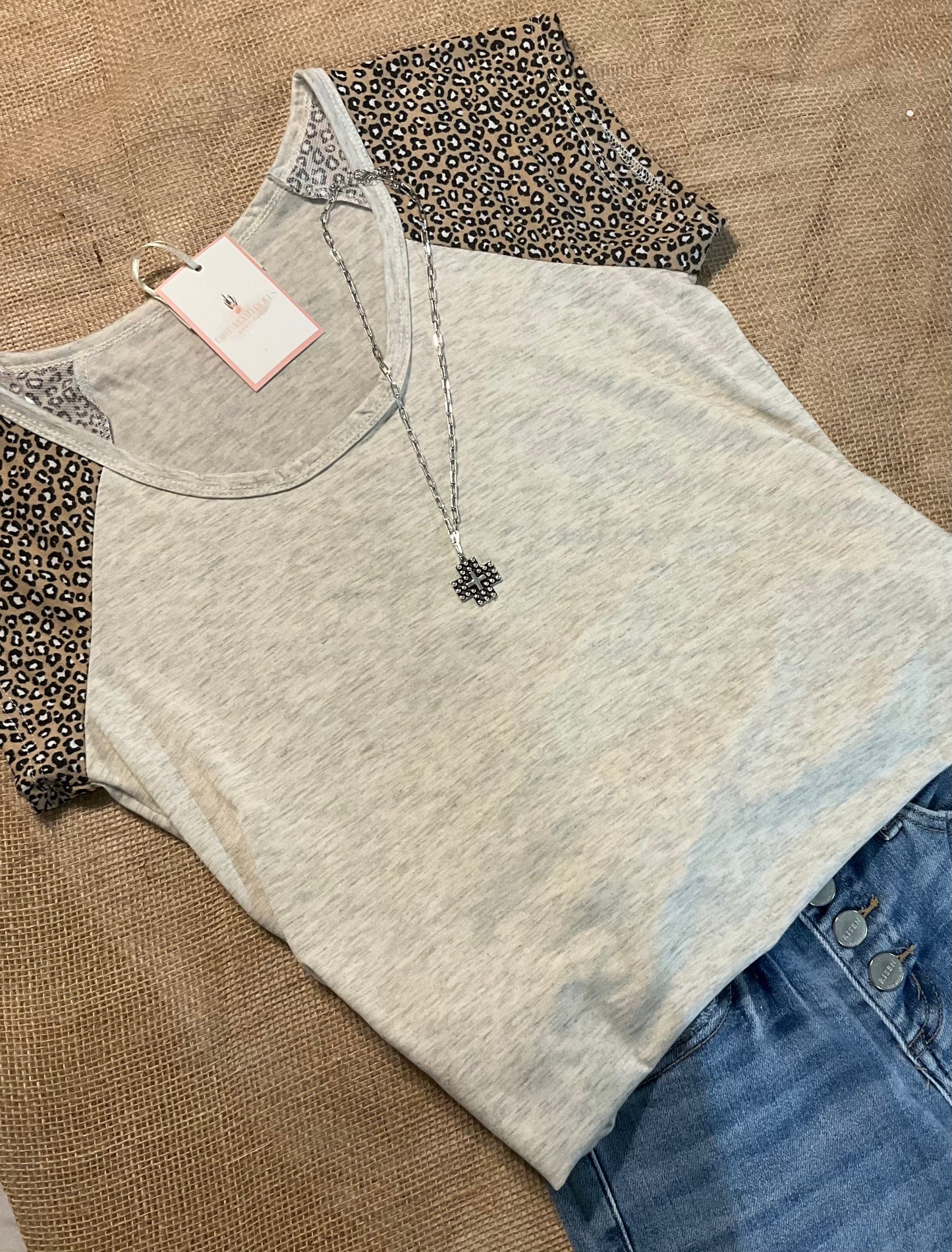 Gloria Leopard Sleeve Top featuring buttery soft fabric with bold leopard print sleeves, offering a chic and comfortable statement piece for any outfit.