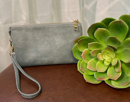 Poteet Crossbody bag with three compartments and built-in card holders, offering versatile crossbody and wristlet carrying options for stylish convenience.