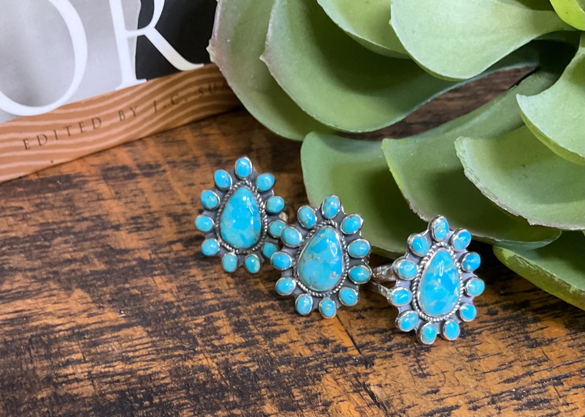 Minot Sterling & Turquoise Ring with a large teardrop turquoise center stone and surrounding oval turquoise stones set in sterling silver