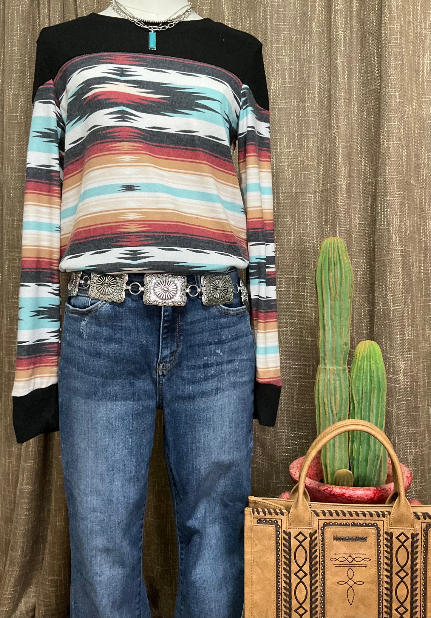 Robin Aztec Top with vibrant Aztec-inspired patterns, featuring long sleeves and a relaxed, comfortable fit. The top showcases bold geometric designs and earthy tones, perfect for a chic, Southwestern look.