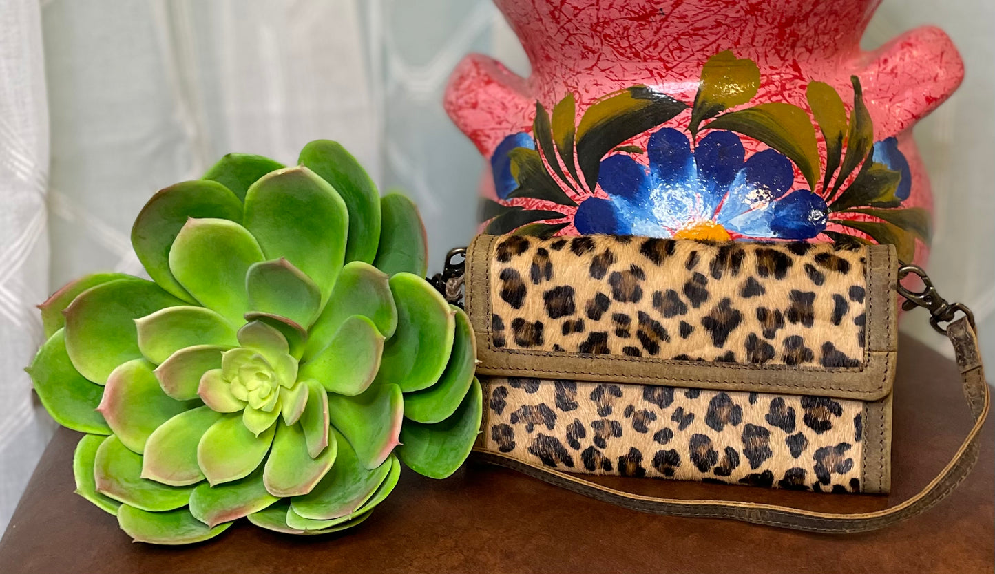 Schertz Crossbody Wallet – cheetah print hair-on-hide design with adjustable strap, spacious interior for essentials – playful, stylish accessory.