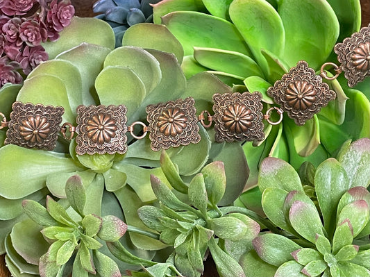 Square flower concho belt with adjustable 38-inch length and 3-inch extender in silver or copper – statement accessory for any outfit.