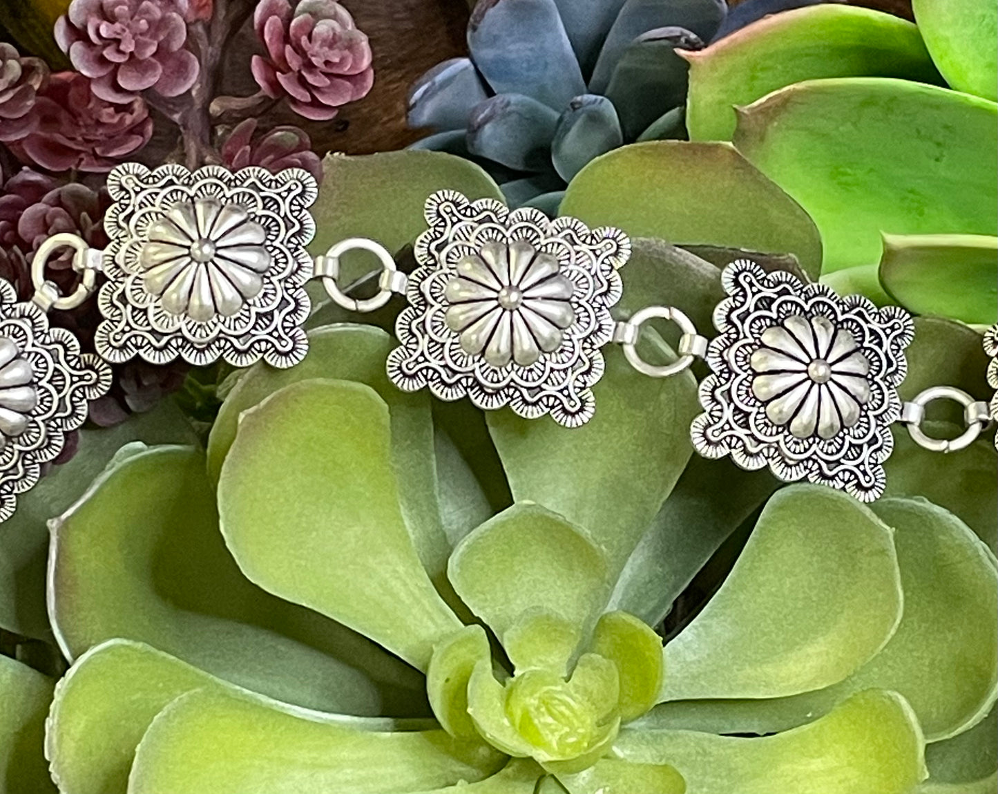 Square flower concho belt with adjustable 38-inch length and 3-inch extender in silver or copper – statement accessory for any outfit.