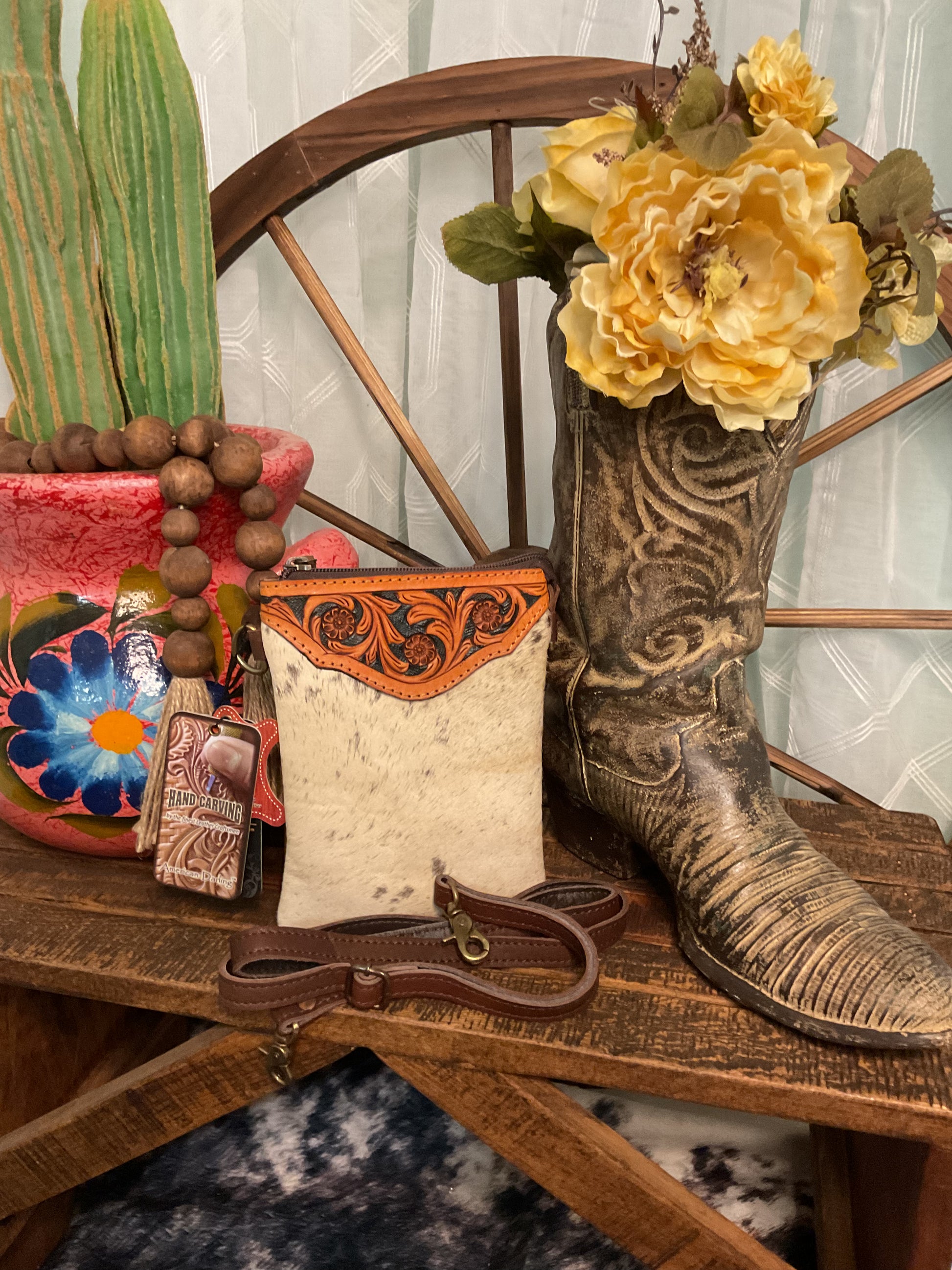American Darling brand hair-on cowhide crossbody bag with hand tooled genuine leather accent in a floral pattern