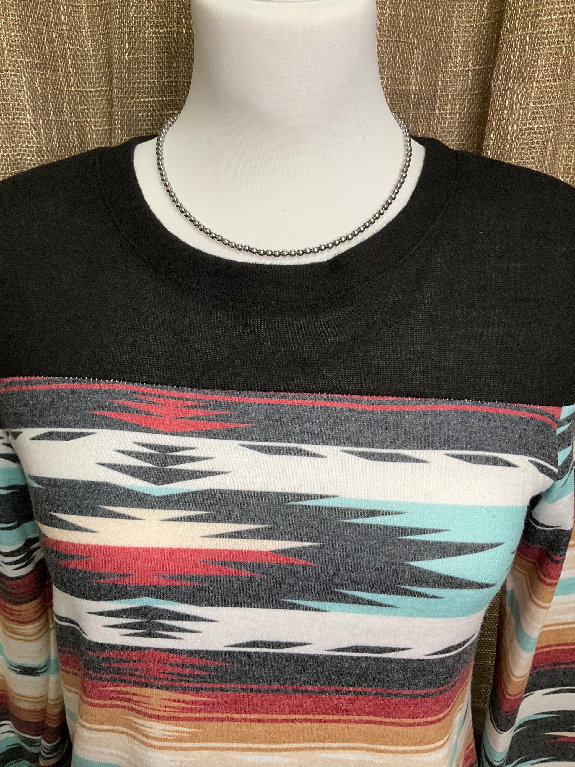 Robin Aztec Top with vibrant Aztec-inspired patterns, featuring long sleeves and a relaxed, comfortable fit. The top showcases bold geometric designs and earthy tones, perfect for a chic, Southwestern look.