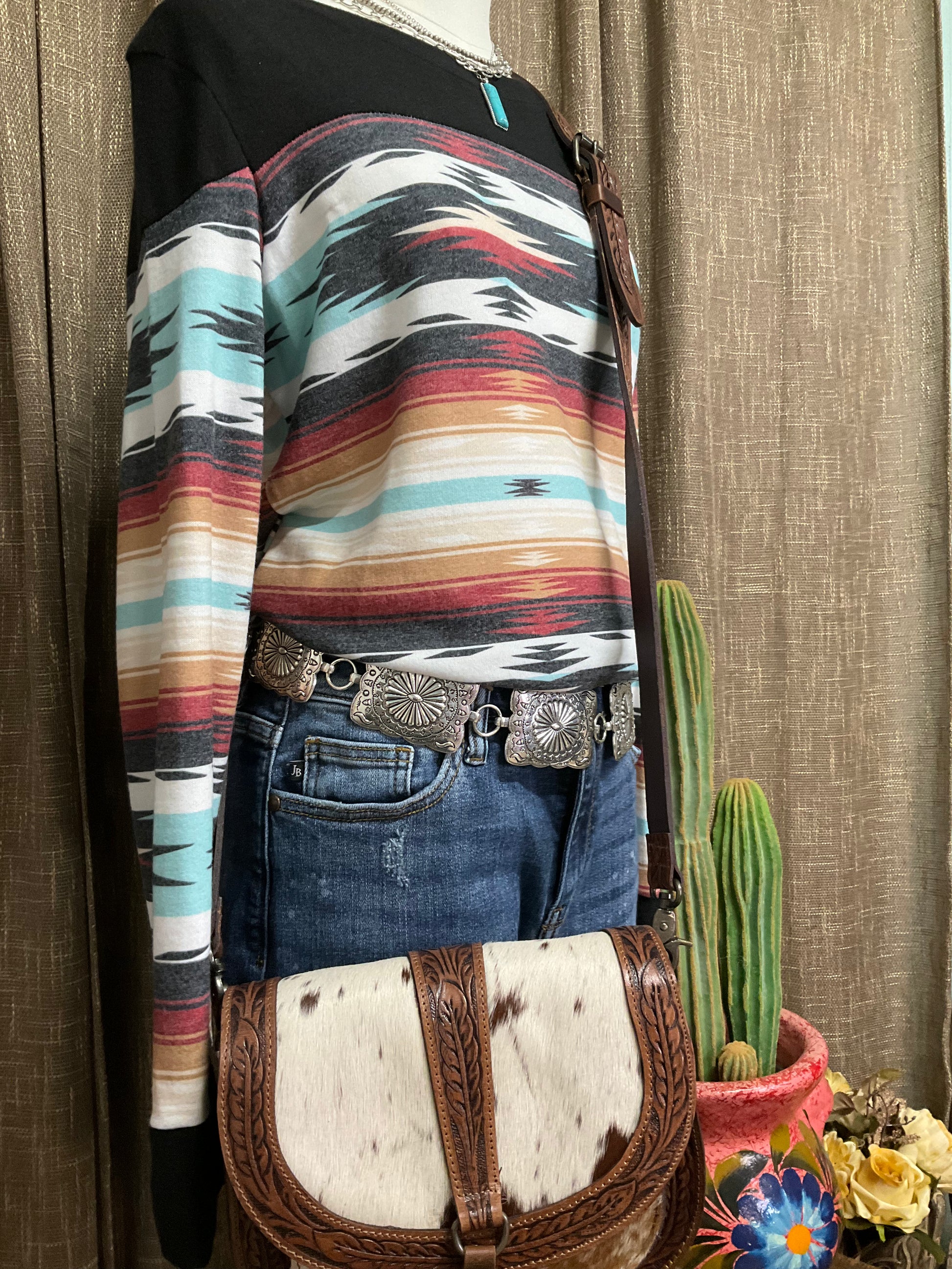 Robin Aztec Top with vibrant Aztec-inspired patterns, featuring long sleeves and a relaxed, comfortable fit. The top showcases bold geometric designs and earthy tones, perfect for a chic, Southwestern look.