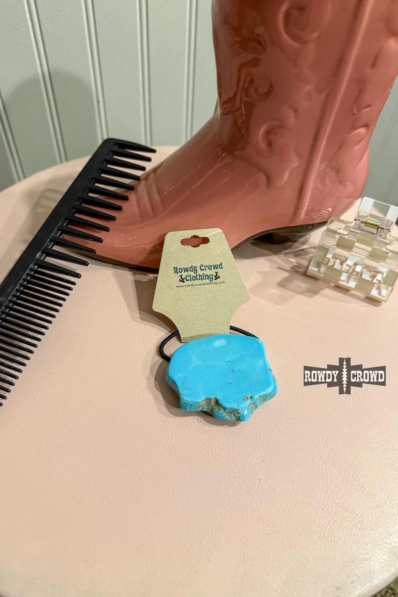 Saddle up in style with the Turquoise Rock Ponytail Holder – a one-of-a-kind accessory featuring a natural turquoise slab, adding a bold, cowgirl-cool touch to your ponytail