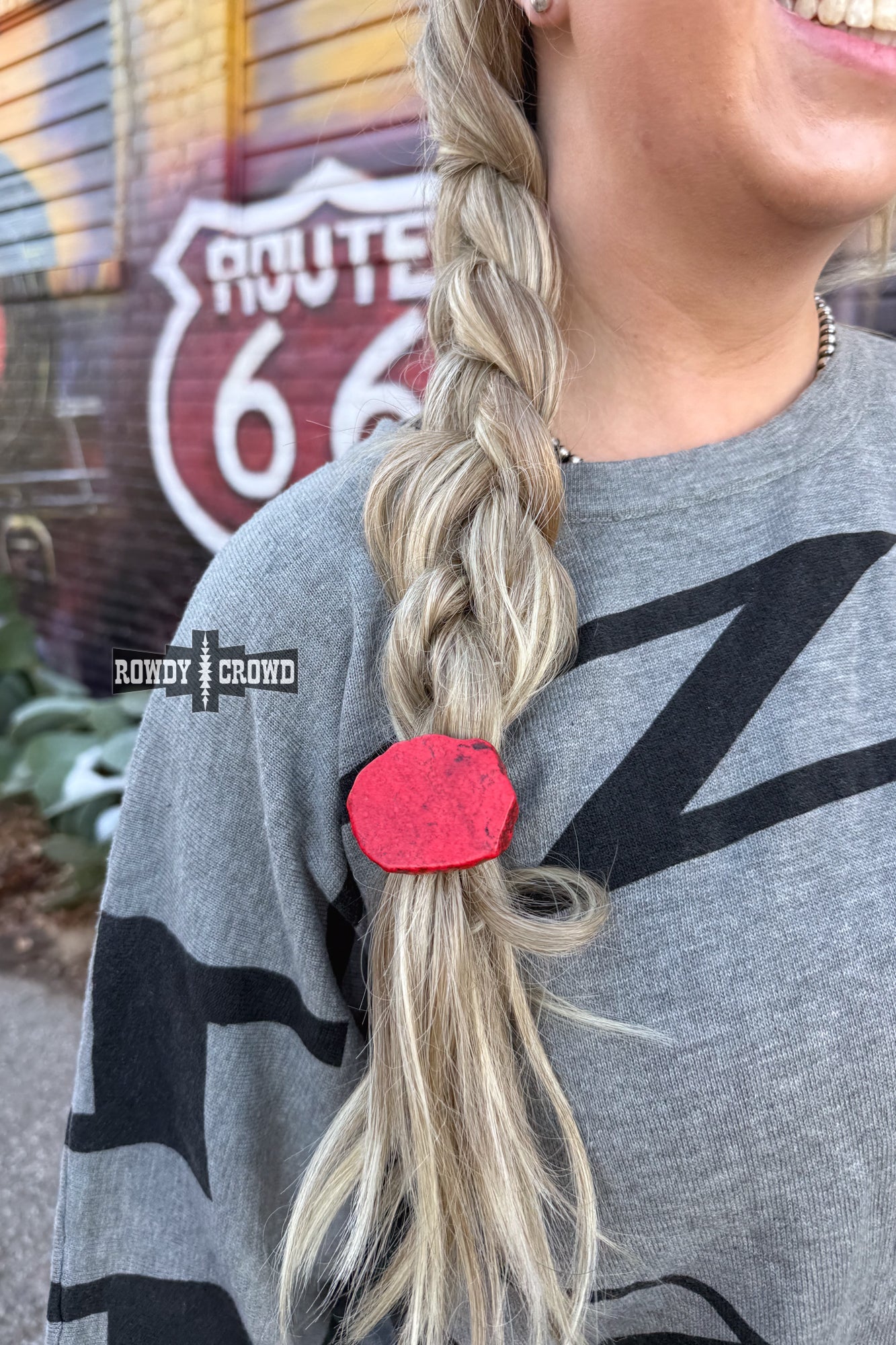 Never have a bad hair day again with the Red Rock Ponytail Holder – a playful hair accessory featuring a uniquely sized and colored red slab rock, adding a touch of quirky style to your look.
