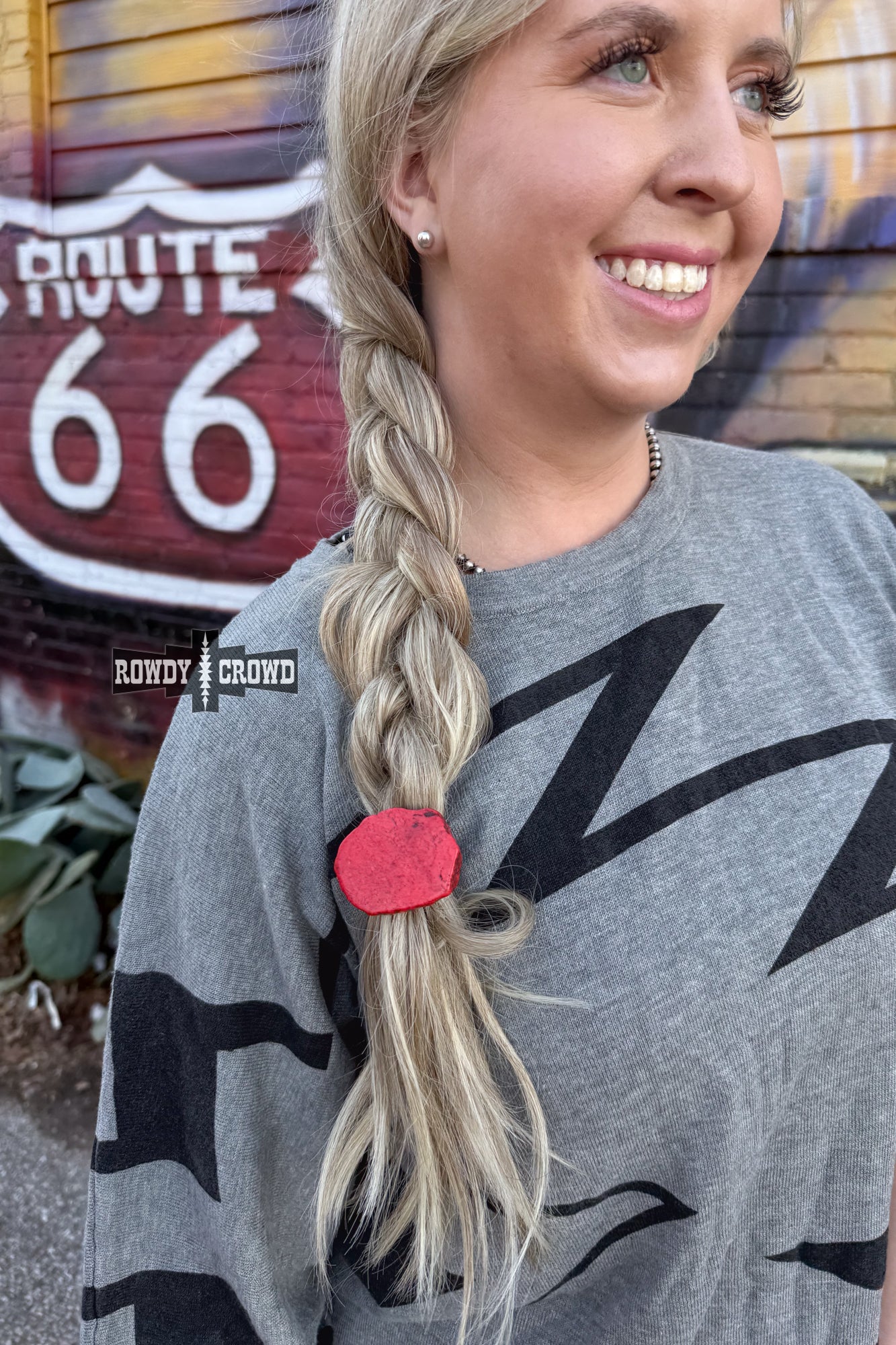 Never have a bad hair day again with the Red Rock Ponytail Holder – a playful hair accessory featuring a uniquely sized and colored red slab rock, adding a touch of quirky style to your look.