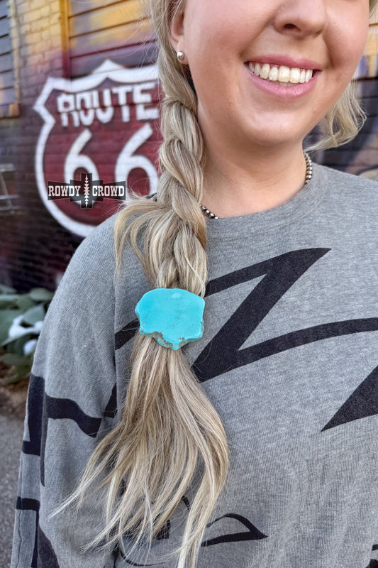 Saddle up in style with the Turquoise Rock Ponytail Holder – a one-of-a-kind accessory featuring a natural turquoise slab, adding a bold, cowgirl-cool touch to your ponytail