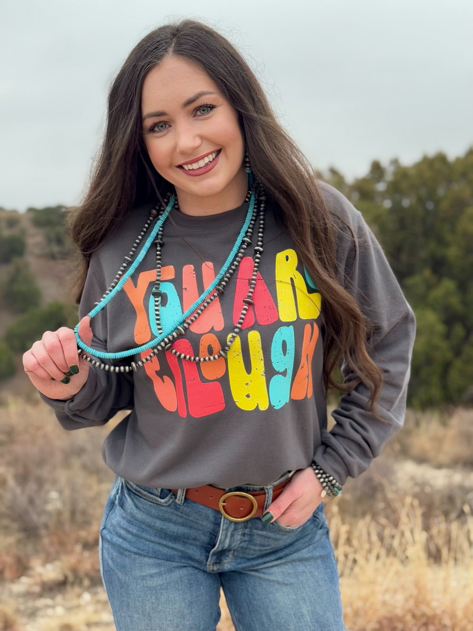 Dark grey Bella Canvas short sleeve tee with a colorful “You Are Enough” design in multicolored ink. The soft, breathable fabric and classic fit make it a versatile and empowering piece.