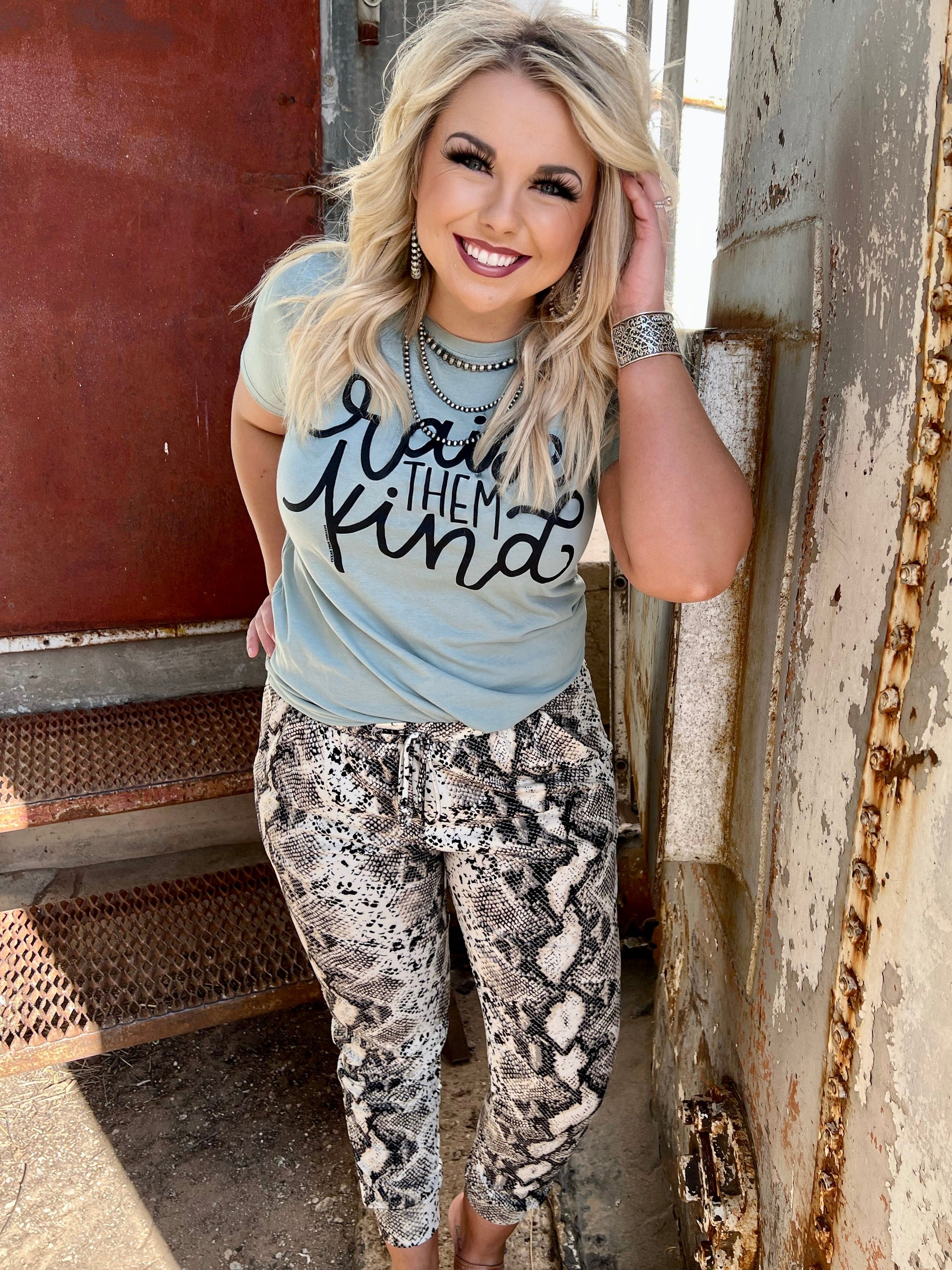 A pair of Snakeskin Lightweight Buttery Joggers featuring a subtle snakeskin pattern, elastic waistband with drawstring, and a relaxed fit. The ultra-soft, buttery fabric drapes comfortably for a casual, everyday look.