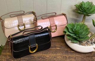 Two tone faux leather handbag featuring crocodile texture and metal ring flap closure