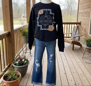 Risen Austyn mid-rise straight jeans, best-selling denim with light distressing and cuffed ankles, women’s classic blue jeans.  Shown on mannequin with graphic sweatshirt