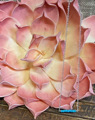 Close-up of the Parita Kingman Turquoise Necklace, a 16-inch silver chain featuring a faceted Kingman Turquoise center stone, displayed against a neutral backdrop with soft lighting.