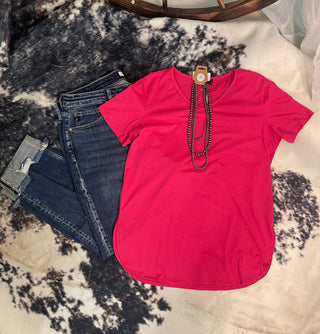 Brystal Top in bright pink with scoop neckline and curved hem styled with denim jeans