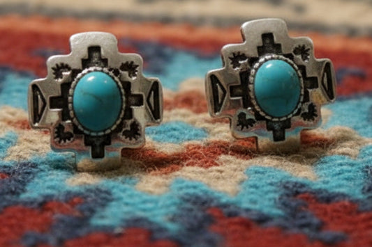 Small silver-tone western stud earrings with turquoise-style center stones and geometric engraved detail, approximately half an inch in size.