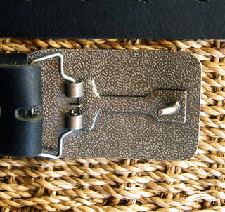 Metal western belt buckle with sunset cowgirl scene and horseshoe detail