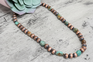     Rustic copper bead necklace with turquoise stones for a warm western inspired look