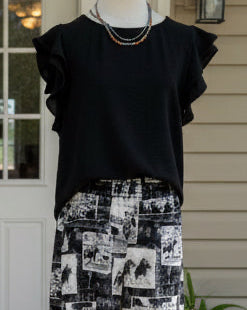 Versatile black boutique top with relaxed fit and feminine details