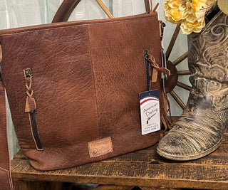 American Darling Portland Bag with cheetah-print hair-on cowhide, gold splatter, leather tassel, concealed carry pocket, and genuine leather construction