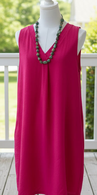 Bright pink sleeveless dress with v neckline and front pleat detail, lightweight casual boutique dress with pockets