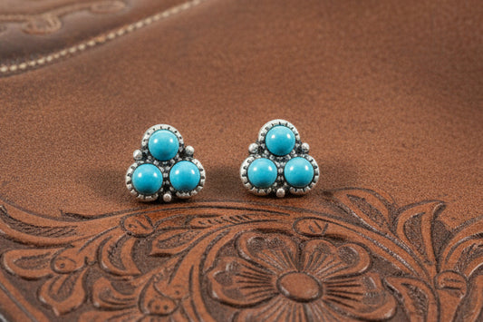 Small silver-tone stud earrings with three turquoise-style stones arranged in a cluster, approximately half an inch in size.