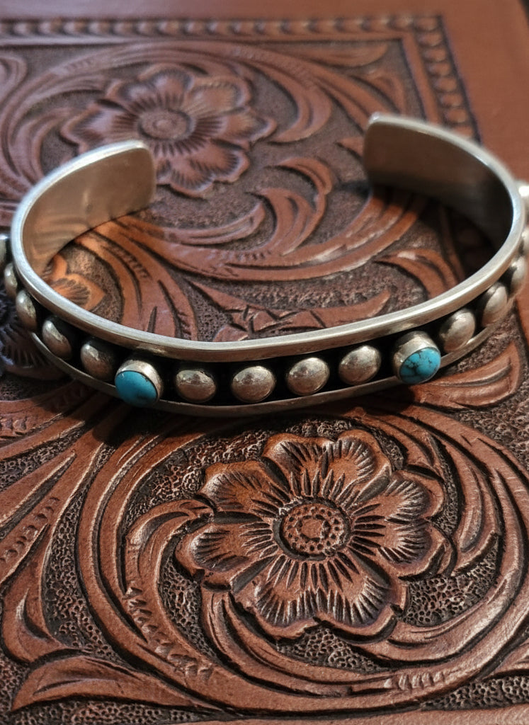 Remuda Sterling Cuff featuring polished sterling silver band with turquoise stones in an open cuff design