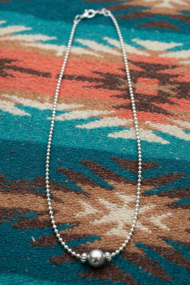 Sterling silver pearl necklace with large center pearl and saucer bead accents, adjustable extender chain.