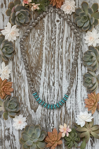 Western beaded statement necklace with ornate silver-tone beads and turquoise disc bead accents